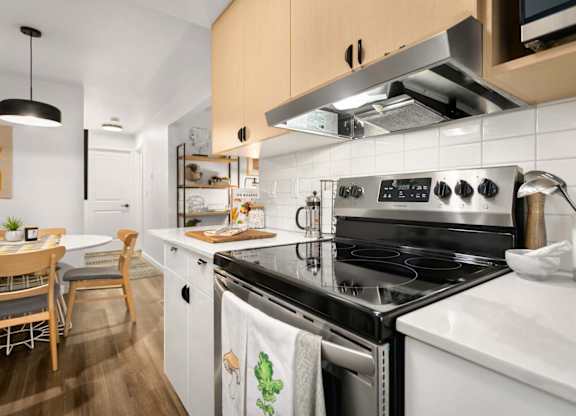 Modern kitchen with stove and range hood at Scout Apartments, Kirkland