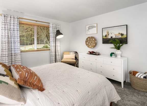 Bedroom with white dresser and natural light at Scout Apartments, Kirkland