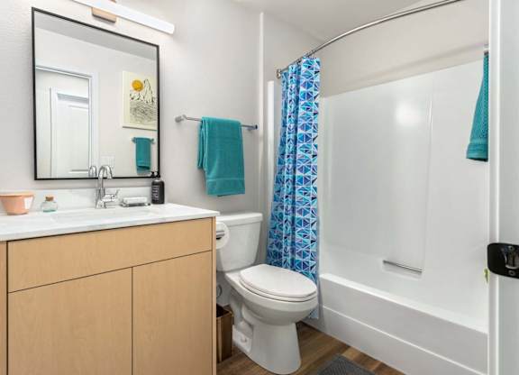 Bathroom with white shower tub and geometric curtain at Scout Apartments, Kirkland, WA 98034