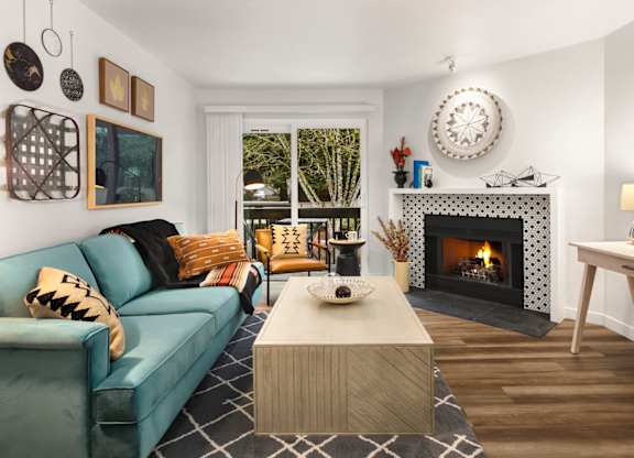 Living room with fireplace and view of balcony at Scout Apartments, Kirkland, 98034