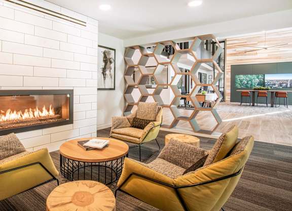 A modern living room with a fireplace and a large abstract art piece on the wall.at Axle, Seattle Washington 