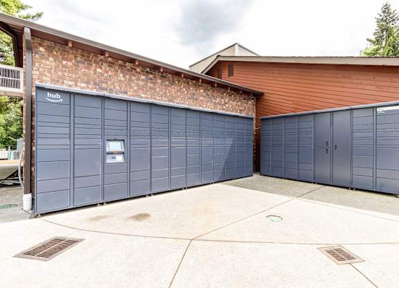 A building with a brick wall and a garage door.