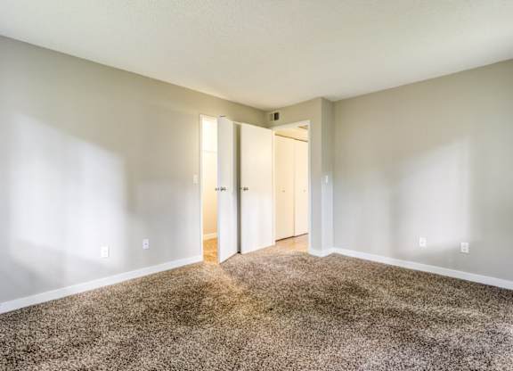 A room with a carpeted floor and white walls.