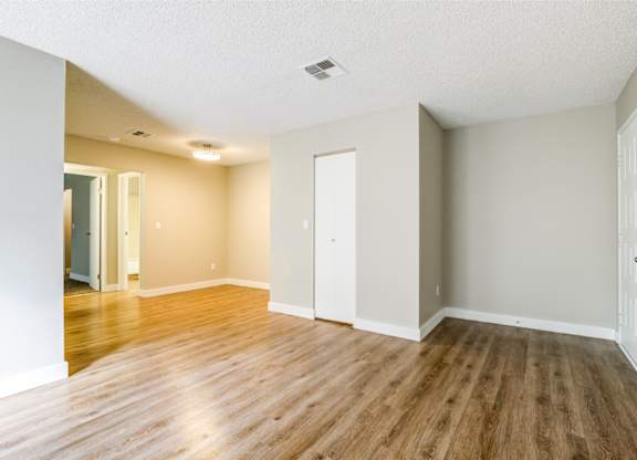 A room with wooden floors and white walls.