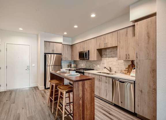 A kitchen with wooden cabinets and a white countertop.