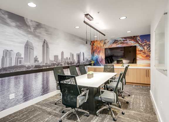 A conference room with a cityscape mural on the wall.