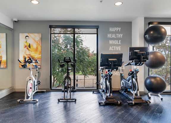 A gym with exercise equipment and a sign that says