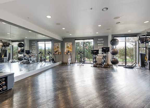 A gym with a variety of equipment and a sign that says
