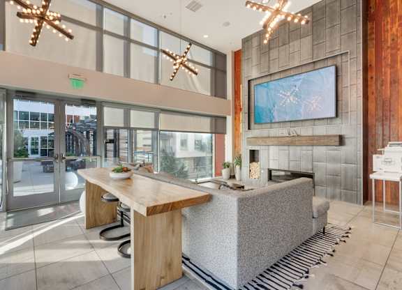 A modern kitchen with a wooden island and a large window.