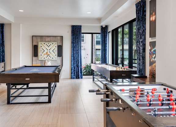 A foosball table is in a room with a pool table.