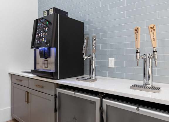 A black coffee machine with a digital display is on a kitchen counter.