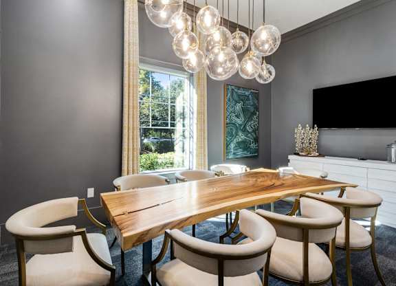 A dining room with a wooden table and chairs.