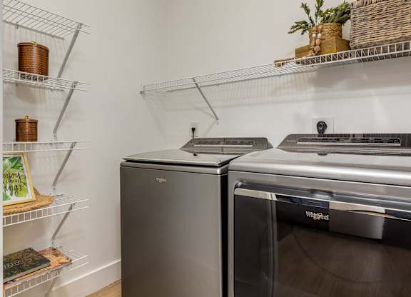 A kitchen with a stainless steel oven and a black dishwasher.