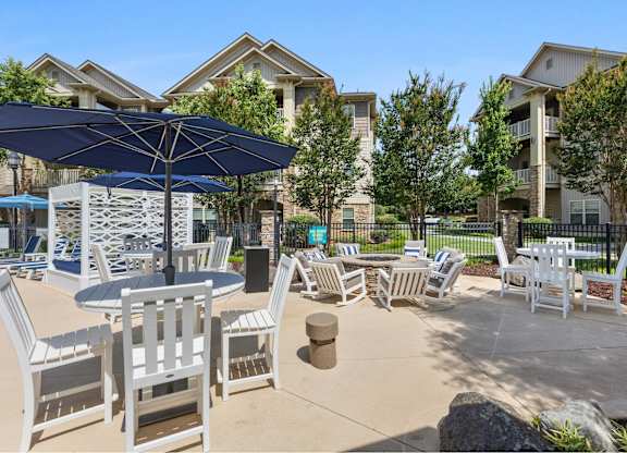 A sunny day at a residential outdoor area with a table and chairs set up.