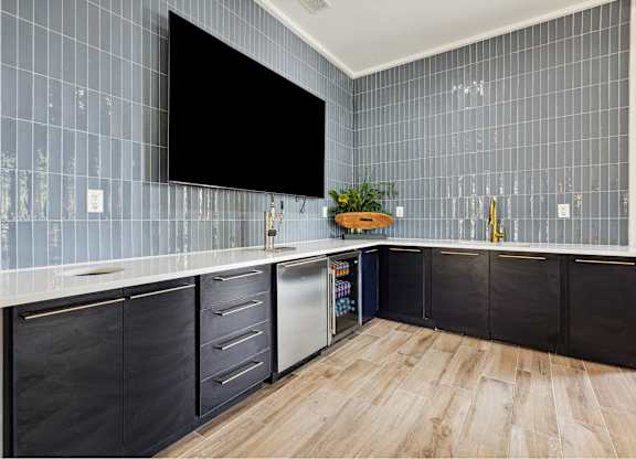 A kitchen with a black screen on the wall.