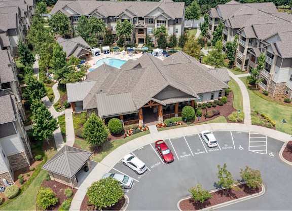 A large building with a pool in the middle of a parking lot.
