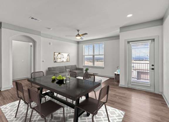 A dining room with a table set for two.