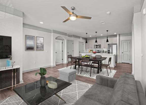 A modern living room with a black coffee table and grey sofa.
