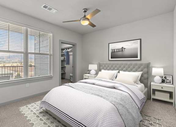 A bedroom with a large bed and a ceiling fan.