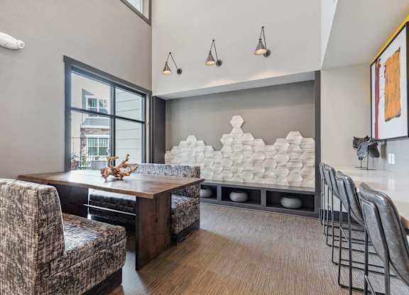 A modern dining room with a wooden table and chairs.