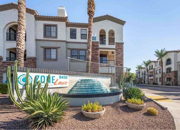 A building with a pool in front of it and a sign that says