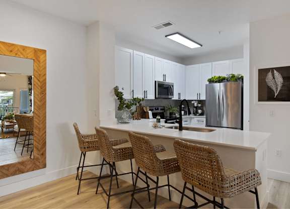 an open kitchen with a large island with bar stools