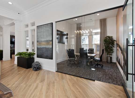 a conference room with glass walls and a table and chairs