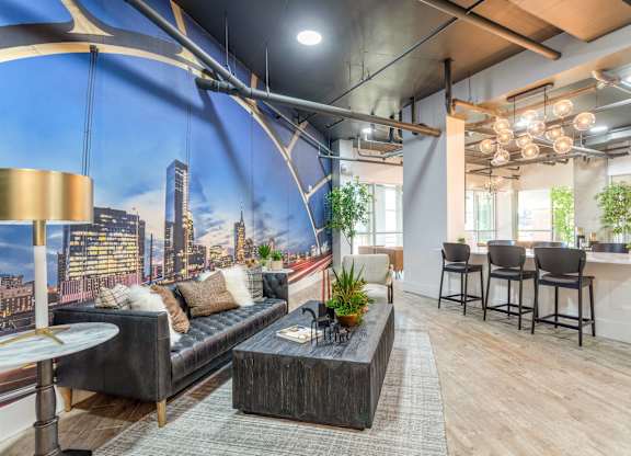 A modern living room with a large cityscape mural on the wall.