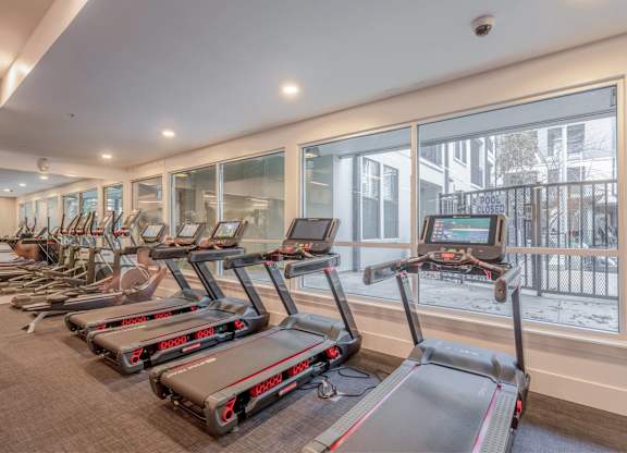 A gym with treadmills and a sign that says closed.