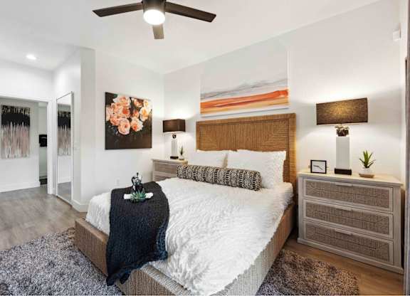 a bedroom with a bed and a ceiling fan
