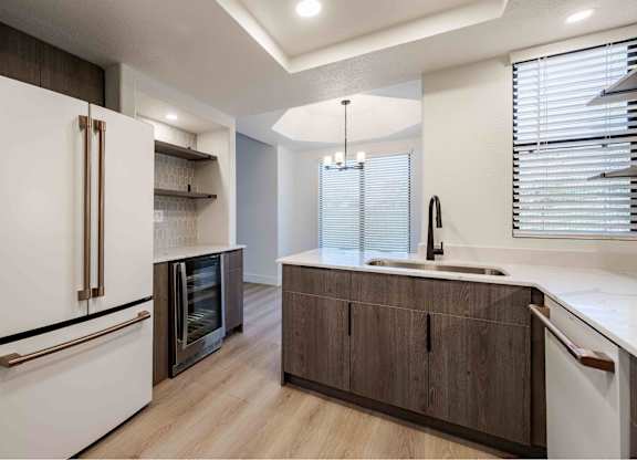 a kitchen with a sink and a refrigerator