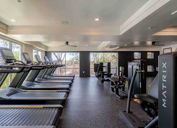 a row of treadmills and exercise machines in a fitness room at slate scottsdale