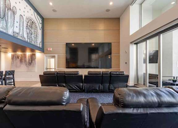 a large screening room with leather couches and chairs