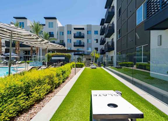 a backyard with a hot tub and grassy area