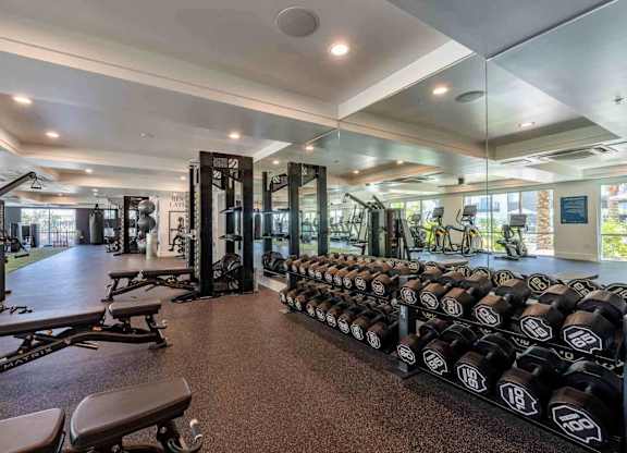 a spacious fitness center with weights and other exercise equipment