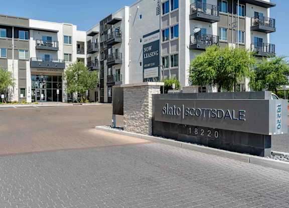 a view of the main entrance to slate scottsdale apartments in the background