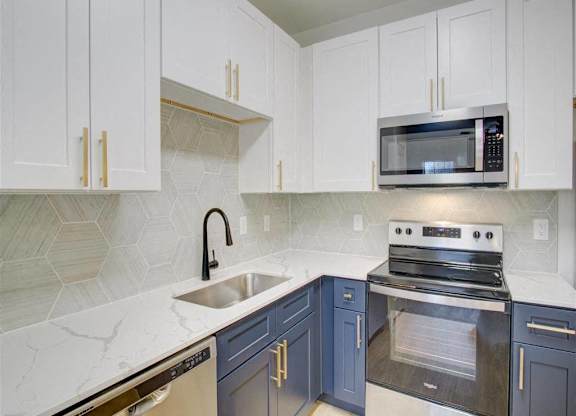 A kitchen with a white counter top and a black oven.