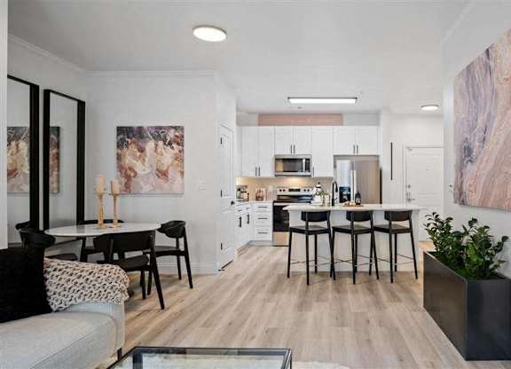 A modern kitchen with a dining table and chairs.