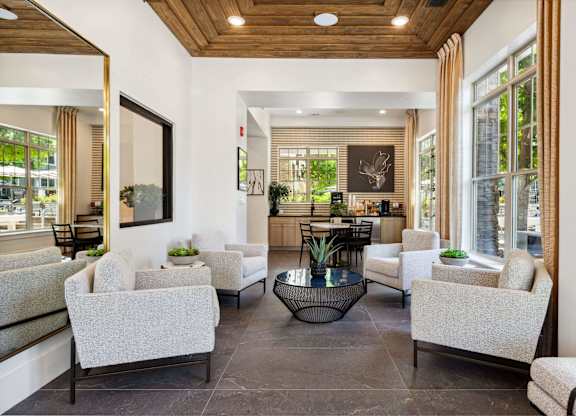A spacious living room with a wooden ceiling and a large mirror on the wall.