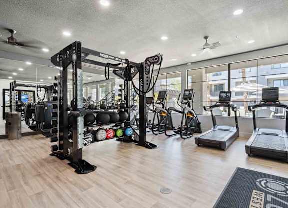 A well-equipped gym with a variety of exercise machines and weights.