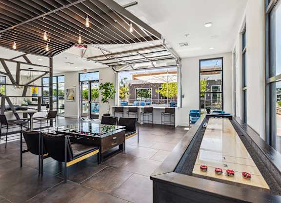 a game room with a foosball table and a ping pong table