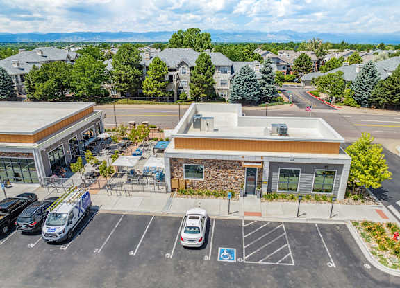 a parking lot with cars in front of a building