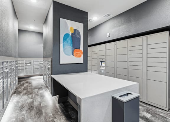a spacious package locker with white cabinets and a colorful painting on the wall