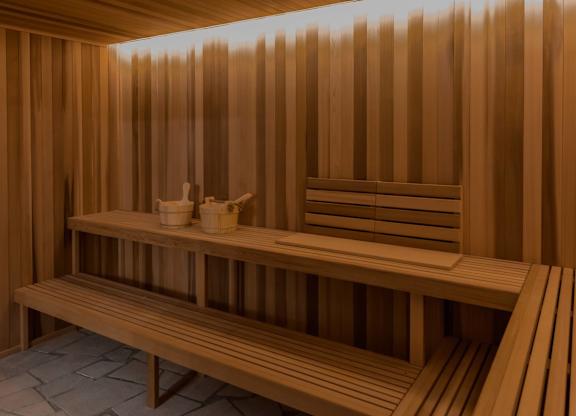 A wooden sauna with benches and towels.