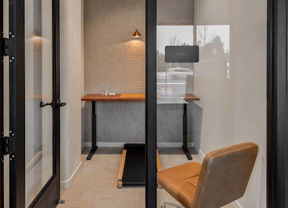 A room with a desk and a chair.