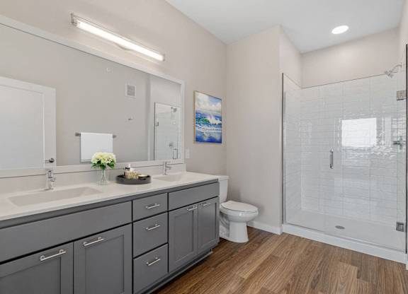 spacious modern bathroom with ample storage and spa shower at The Hallon Apartments, Minnesota