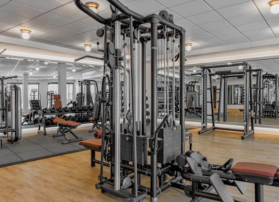 A gym with a variety of equipment including a leg press machine.