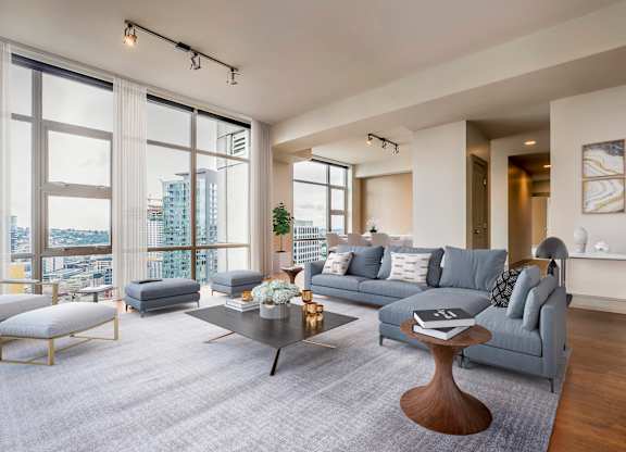 A modern living room with a grey sofa and a coffee table.