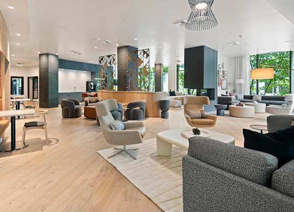A modern living room with a grey sofa and a wooden floor.