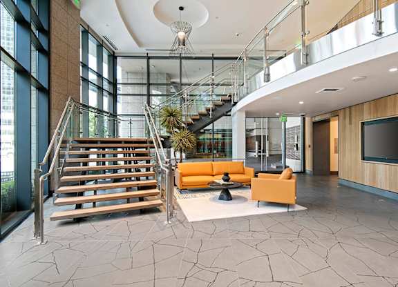A modern interior with a staircase and a television.